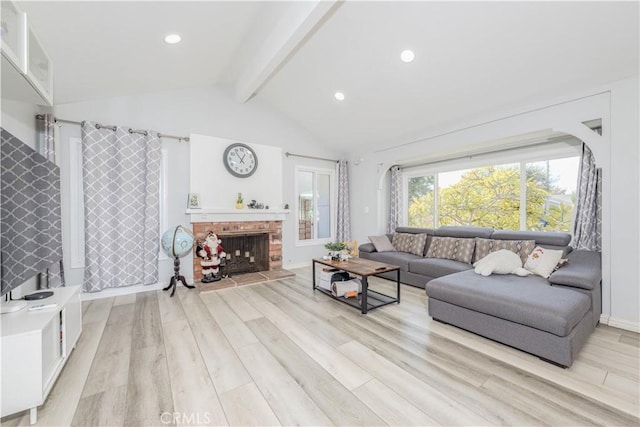 living area with vaulted ceiling with beams, recessed lighting, a fireplace, and light wood-style floors