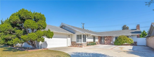 ranch-style home featuring a garage, concrete driveway, fence, a front lawn, and brick siding