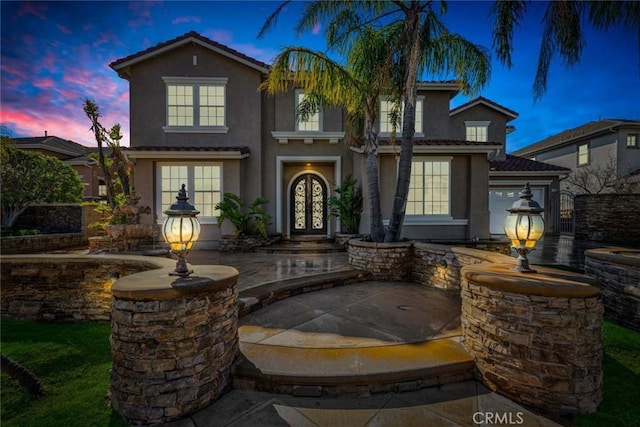 view of front of home with a tiled roof and stucco siding