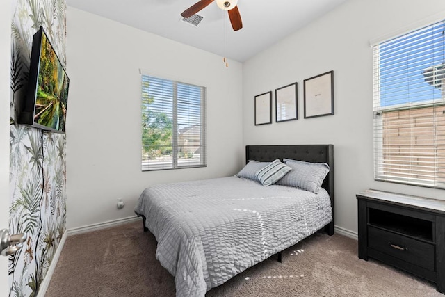 bedroom featuring a ceiling fan, baseboards, visible vents, and carpet flooring