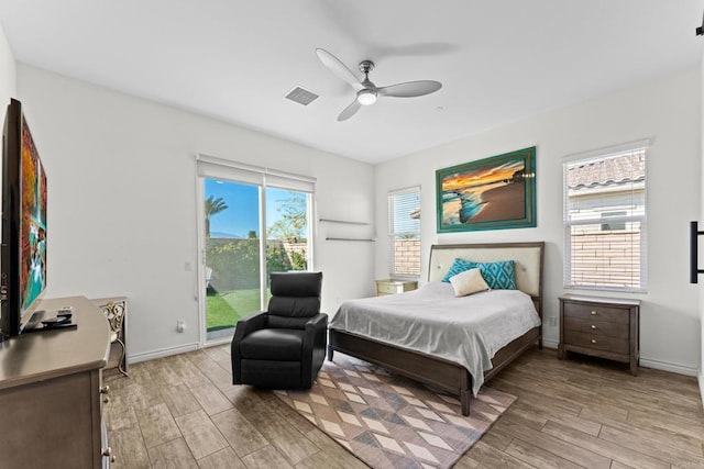 bedroom featuring baseboards, light wood-type flooring, visible vents, and access to exterior