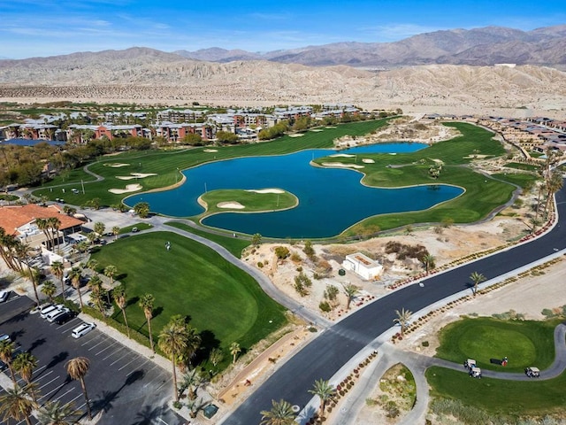 birds eye view of property with golf course view and a water and mountain view