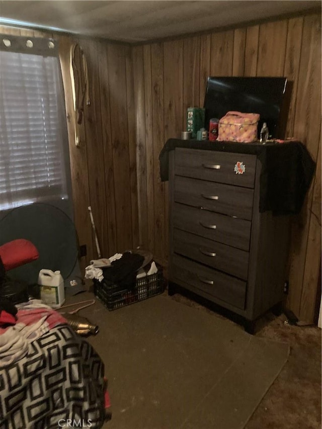 bedroom featuring wooden walls