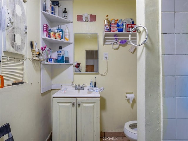 full bath featuring vanity and toilet