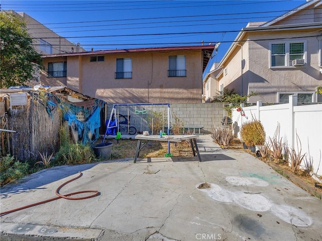 view of patio featuring cooling unit and fence