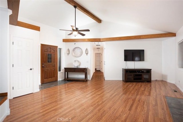 unfurnished living room featuring lofted ceiling with beams, wood finished floors, a ceiling fan, and baseboards