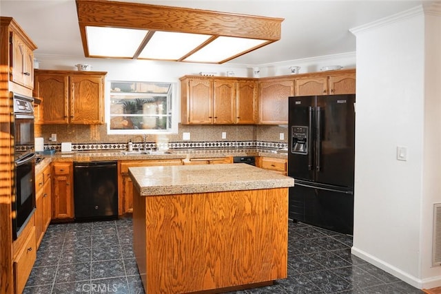 kitchen featuring tasteful backsplash, a center island, a sink, and black appliances