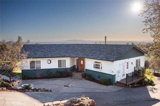 view of front of property featuring roof with shingles