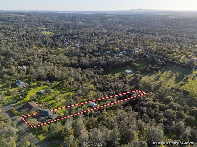 birds eye view of property with a wooded view