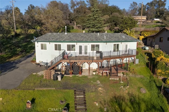 rear view of house featuring a wooden deck, stairway, roof with shingles, and french doors