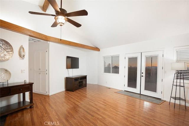 living area with french doors, a ceiling fan, vaulted ceiling, wood finished floors, and baseboards