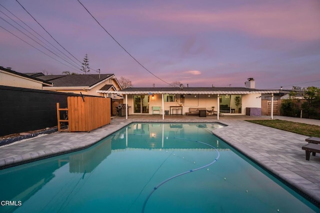 709 Greenbank Ave, Duarte, CA 91010 - pool at dusk with a patio, fence, an outdoor living space, and a fenced in pool