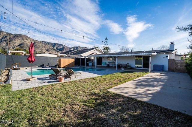 709 Greenbank Ave, Duarte, CA 91010 - back of property featuring a fenced in pool, a fenced backyard, a yard, a patio area, and a mountain view