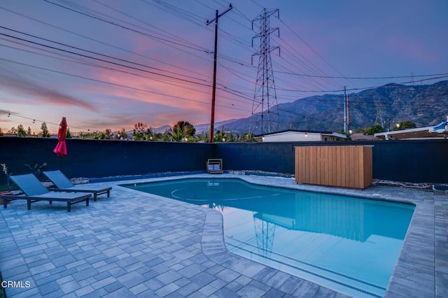 709 Greenbank Ave, Duarte, CA 91010 - pool at dusk featuring a patio area, a fenced backyard, a mountain view, and a fenced in pool