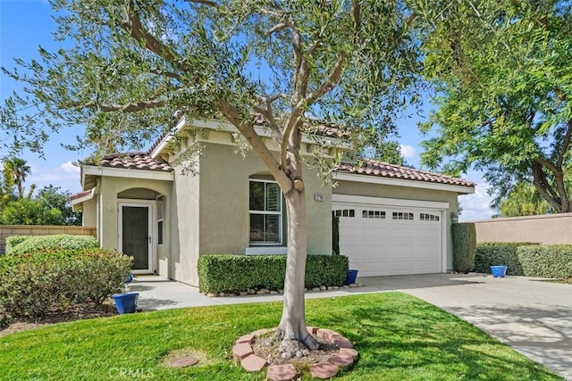 mediterranean / spanish-style house featuring a garage, driveway, a tiled roof, and stucco siding