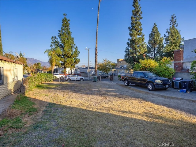 exterior space with a residential view, fence, and a mountain view