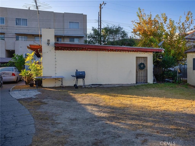 view of side of property with a lawn