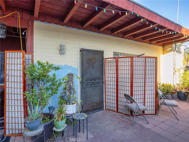 property entrance featuring a patio area and board and batten siding