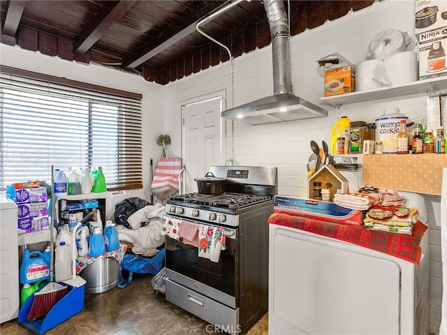 kitchen with stainless steel gas stove, washer / dryer, wooden ceiling, wall chimney exhaust hood, and beam ceiling