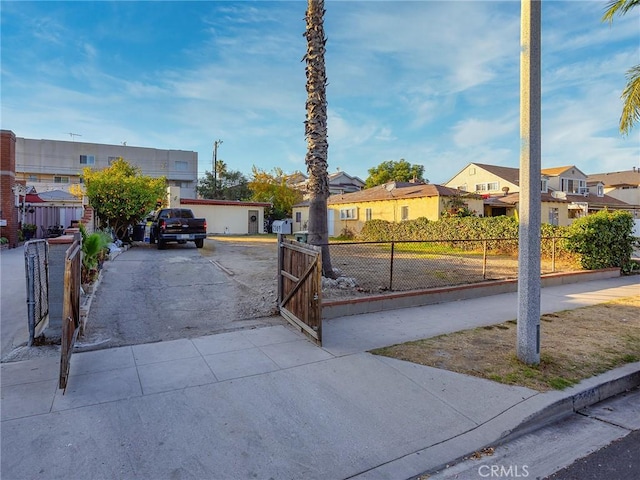 view of front of home featuring fence and a residential view