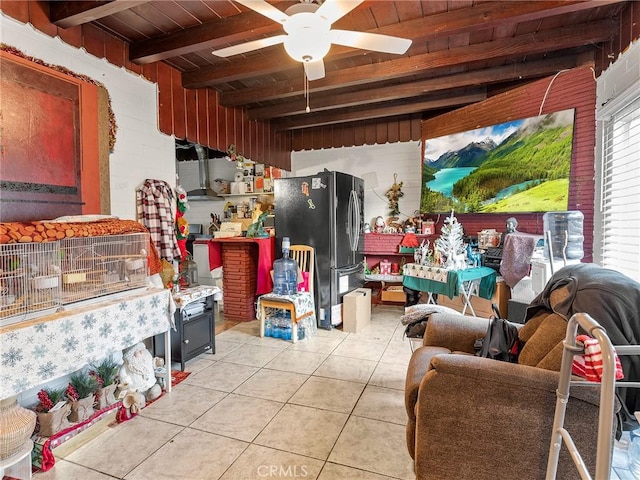 interior space featuring a ceiling fan, beam ceiling, wooden ceiling, and light tile patterned floors