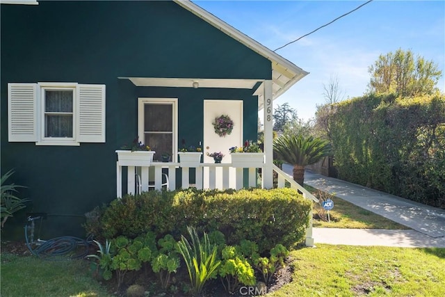 exterior space with a front yard and stucco siding