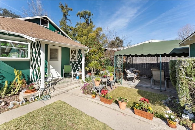 view of patio featuring fence