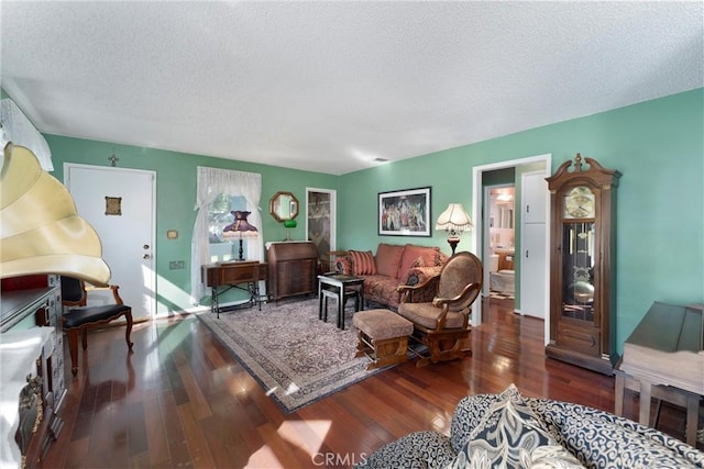 living room with dark wood-style flooring and a textured ceiling