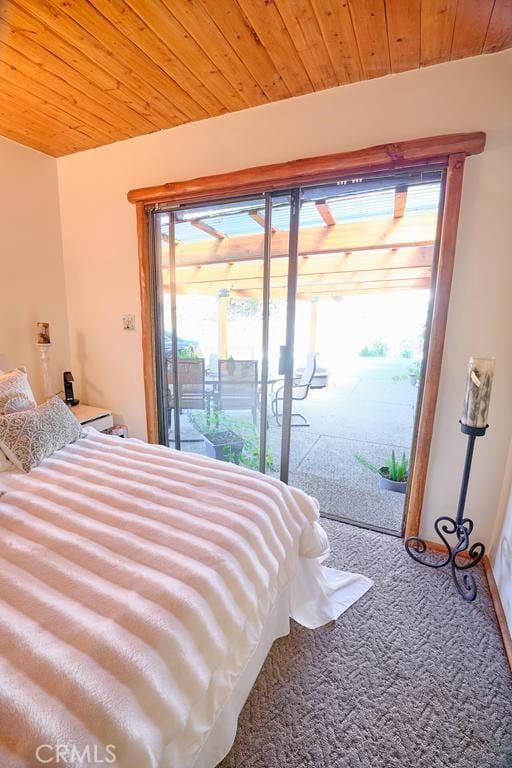 carpeted bedroom featuring wooden ceiling, access to outside, and multiple windows