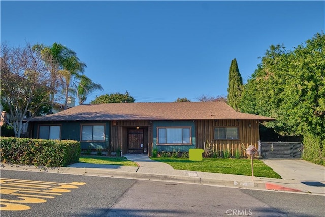 single story home featuring fence, board and batten siding, and a gate