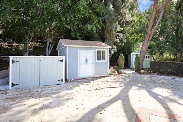 view of shed with fence