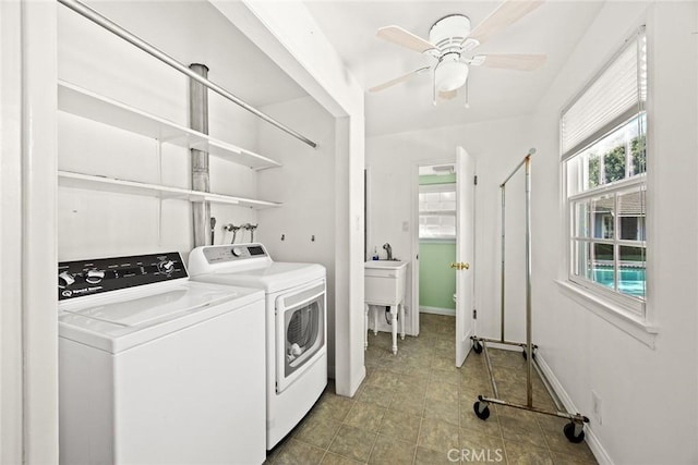 laundry room with ceiling fan, light tile patterned floors, washing machine and dryer, laundry area, and baseboards