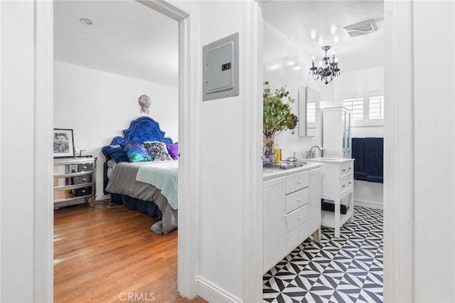 bathroom with a chandelier, connected bathroom, visible vents, electric panel, and tile patterned floors