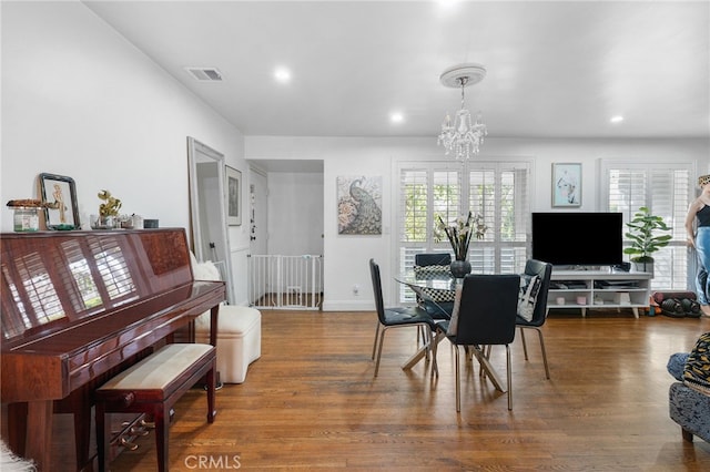 dining area with recessed lighting, visible vents, wood finished floors, a chandelier, and baseboards