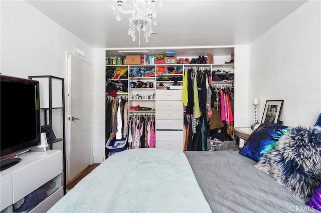 bedroom with a chandelier and a closet