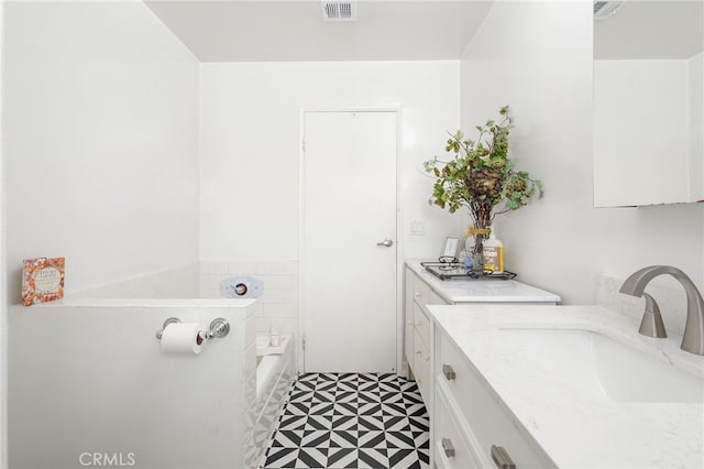 bathroom featuring tile patterned floors, visible vents, and vanity