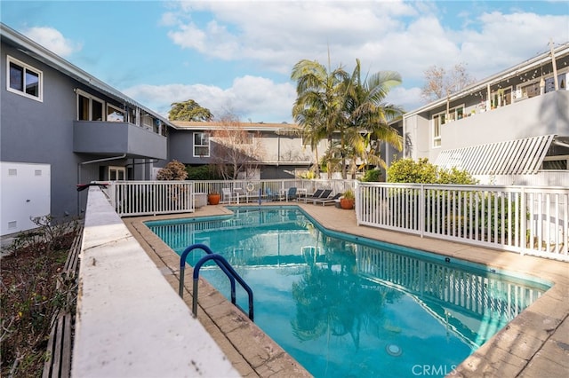 community pool with a residential view and fence