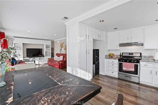 kitchen featuring under cabinet range hood, visible vents, white cabinets, open floor plan, and gas range