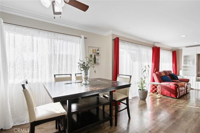 dining space featuring dark wood-style flooring and crown molding