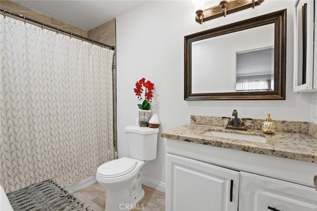 bathroom featuring curtained shower, vanity, and toilet