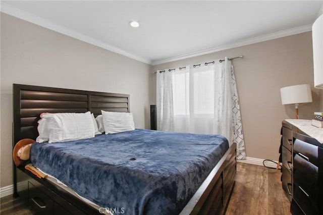 bedroom with crown molding, baseboards, and dark wood-type flooring