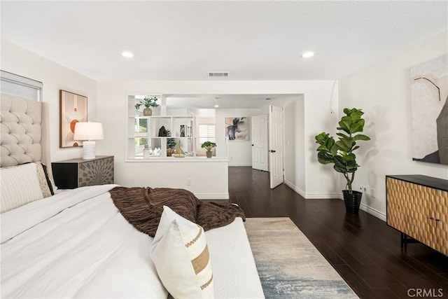 bedroom with recessed lighting, wood finished floors, visible vents, and baseboards