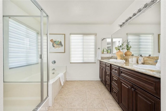 full bathroom featuring a garden tub, double vanity, a stall shower, a sink, and tile patterned floors