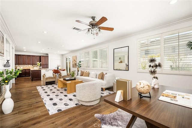 living area with recessed lighting, dark wood-type flooring, a ceiling fan, visible vents, and ornamental molding