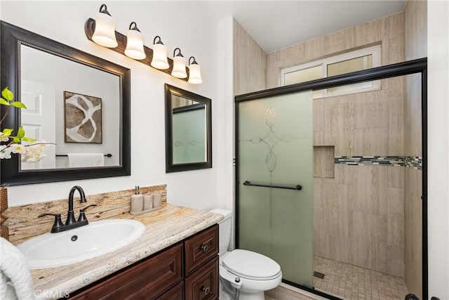 full bath featuring a shower stall, toilet, and vanity