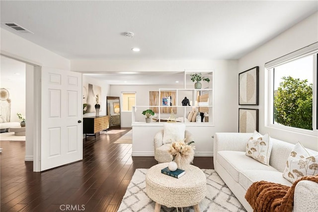 living room with hardwood / wood-style floors, visible vents, and recessed lighting