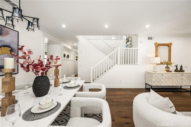 dining area featuring baseboards, visible vents, wood finished floors, stairs, and recessed lighting