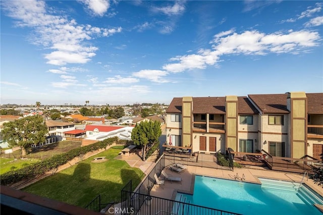 pool with a residential view, fence, and a patio