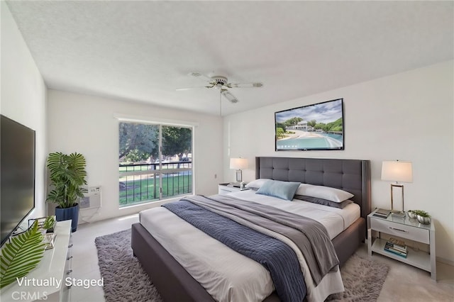 bedroom with access to exterior, a wall mounted AC, and ceiling fan