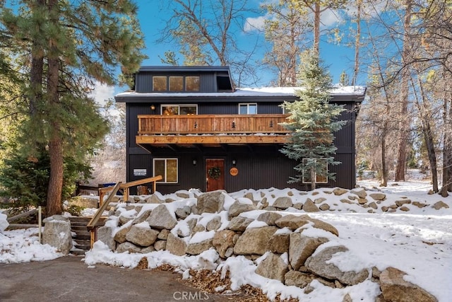 snow covered house with a deck